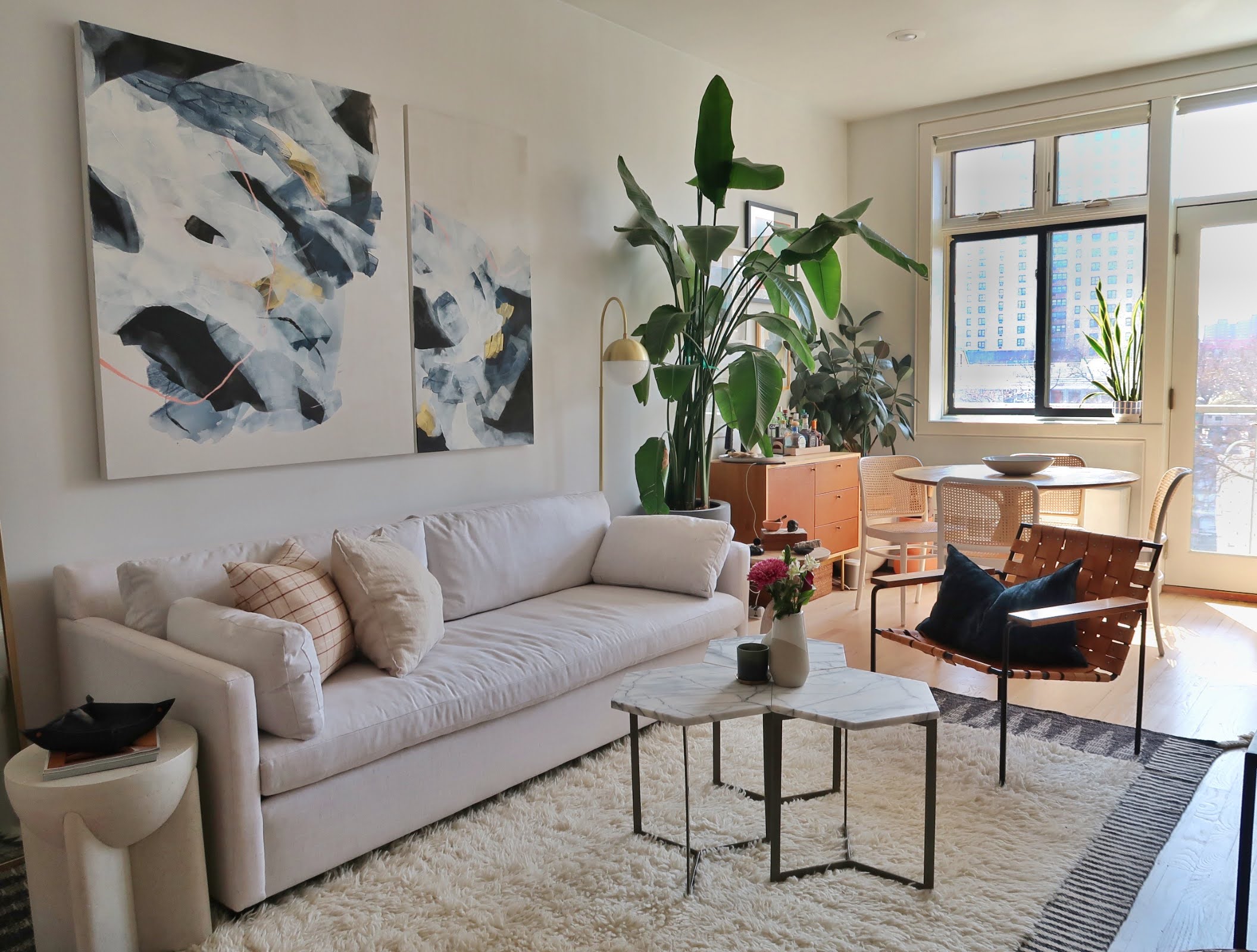 296 East 2nd Street, Unit 4G Manhattan, NY 10009 - Photo 1 of 14 a living room with furniture and a potted plant