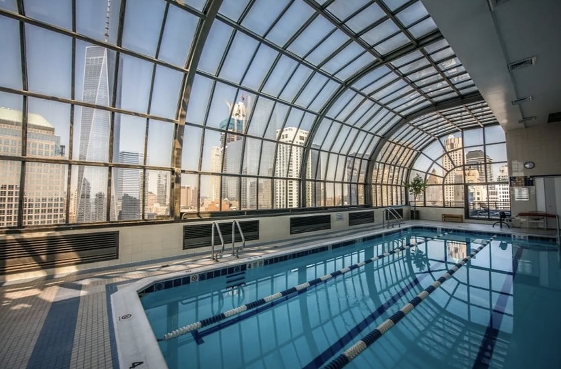 200 Rector Place, Unit 6P Manhattan, NY 10280 - Photo 7 of 10 a kitchen with stainless steel appliances wooden cabinets a sink and a counter top space