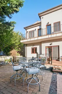 a view of a patio with couches table and chairs and potted plants