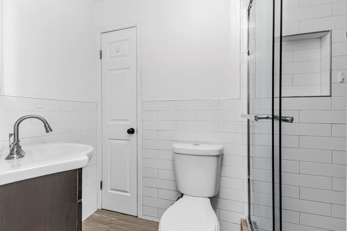 583 Evergreen Avenue Brooklyn, NY 11221 - Photo 10 of 12 a bathroom with a toilet sink and shower