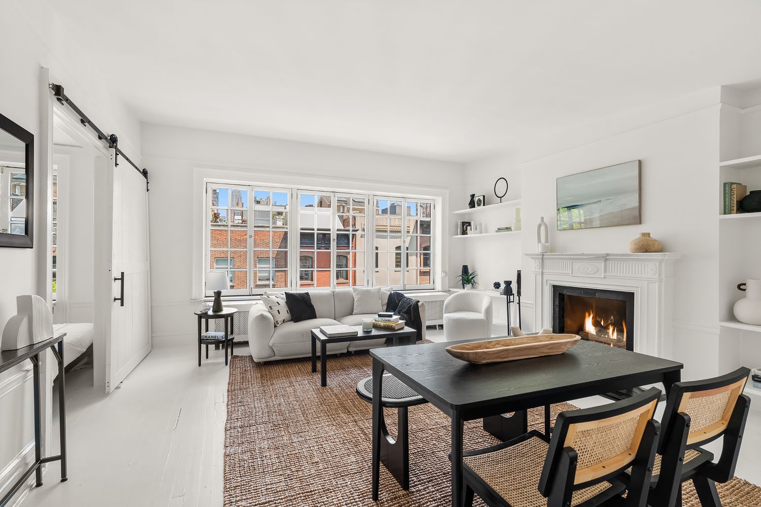 30-32 West 9th Street, Unit 5A Manhattan, NY 10011 - Photo 3 of 18 a living room with furniture a table and a fireplace