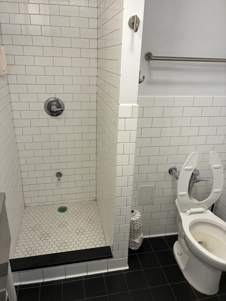 a bathroom with a toilet and a shower
