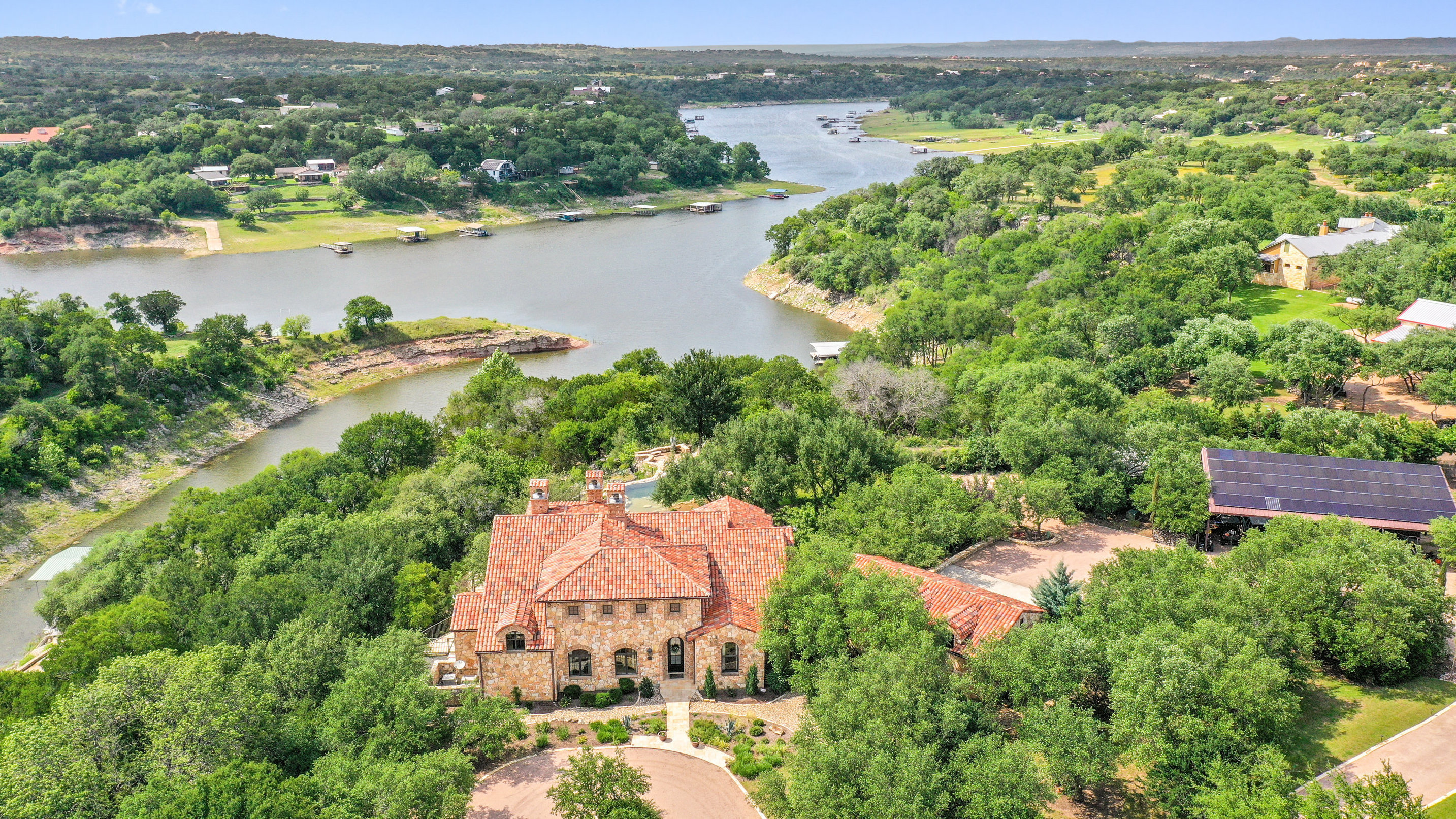 808 Rivercliff Drive Spicewood, TX 78669 - Photo 2 of 71 an aerial view of a house with a lake view