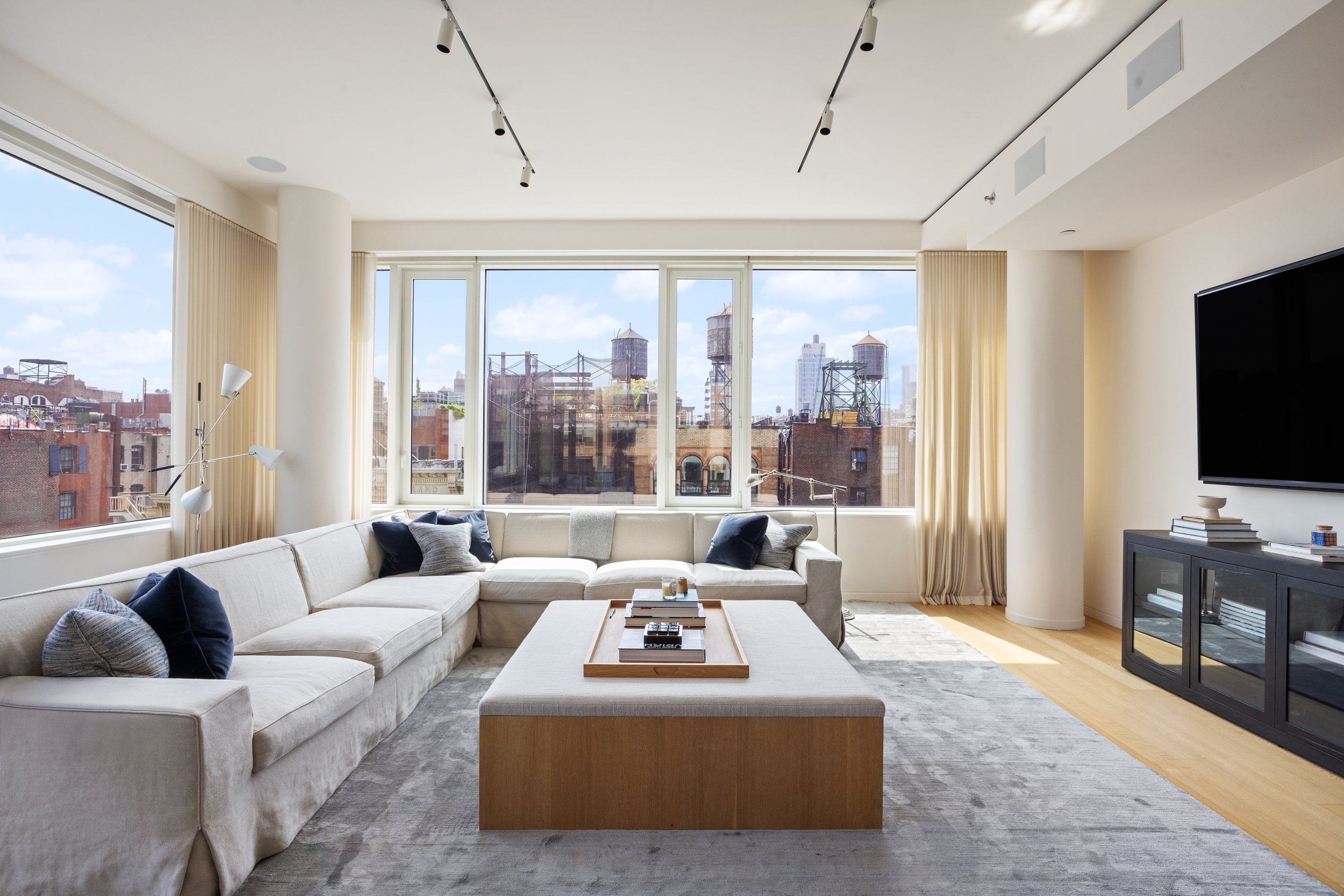 350 West Broadway, Unit 7FL Manhattan, NY 10013 - Photo 3 of 17 a living room with furniture and a flat screen tv