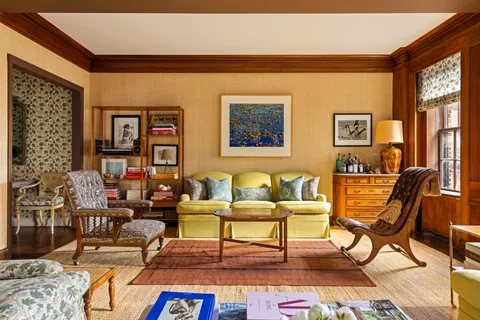 a living room with furniture and a floor to ceiling window