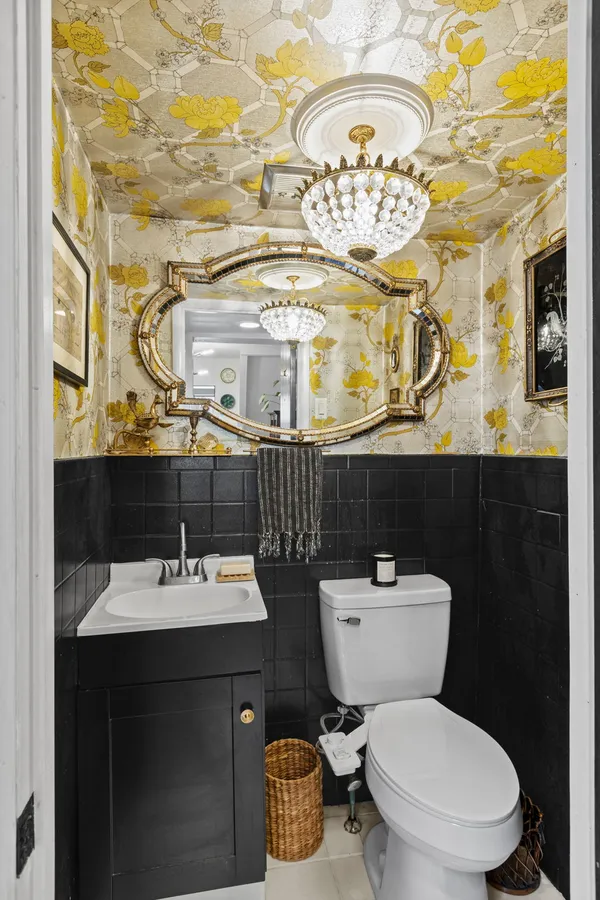 a bathroom with a sink a toilet and a mirror