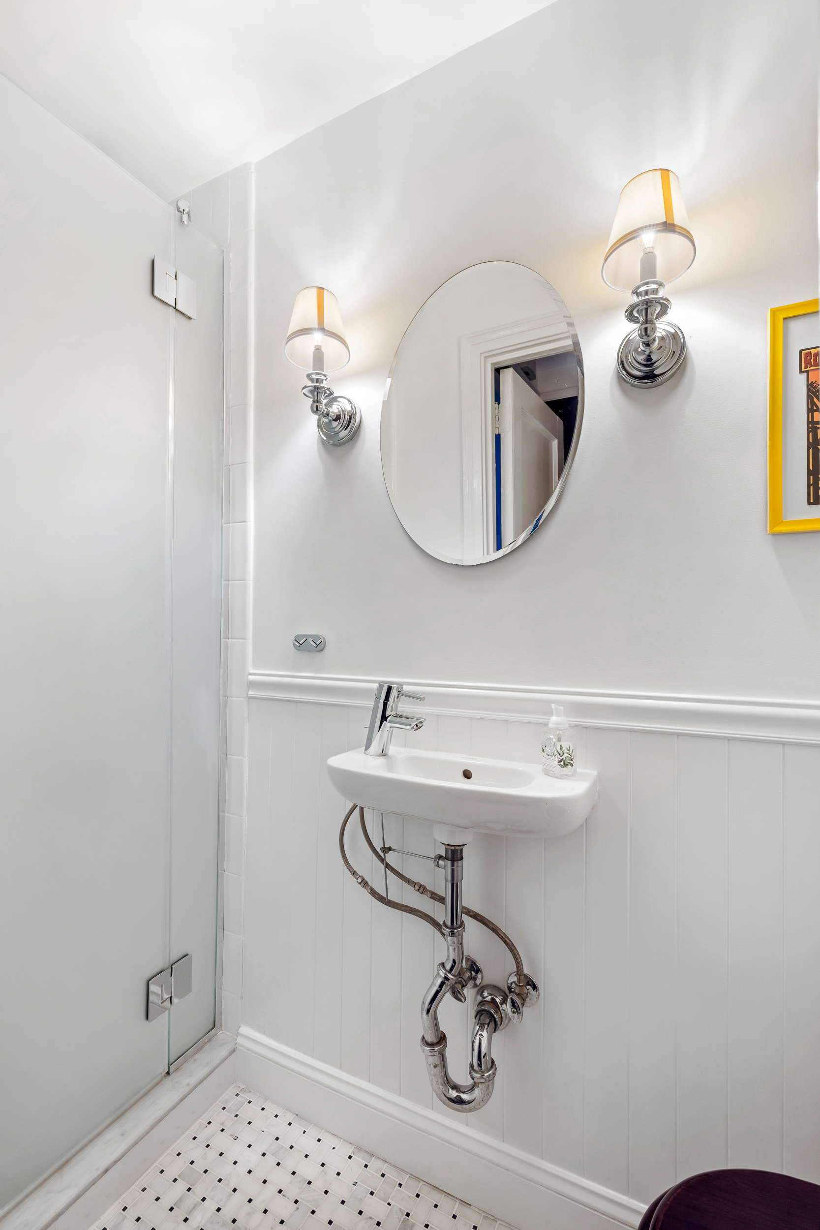 49 East 96th Street, Unit 4D Manhattan, NY 10128 - Photo 11 of 18 a bathroom with a sink and mirror