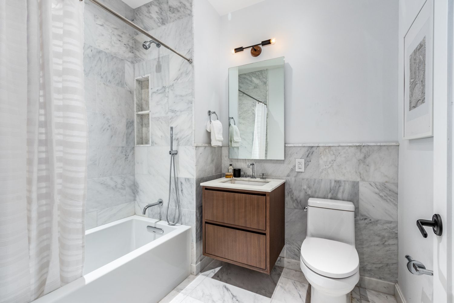 106 Franklin Street, Unit MAIS Manhattan, NY 10013 - Photo 9 of 16 a bathroom with a granite countertop toilet a sink and a bathtub