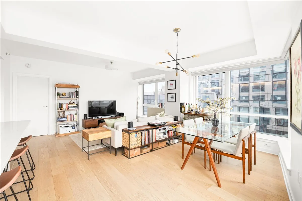 a living room with furniture a rug and a chandelier