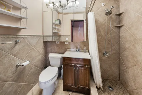 a view of a big room with wooden floor and windows