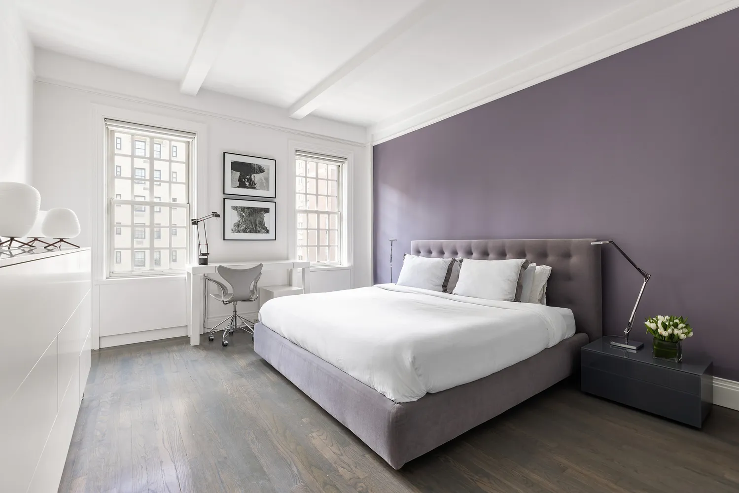 a bedroom with a bed table and a window