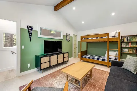 a living room with furniture flat screen tv and gym equipment