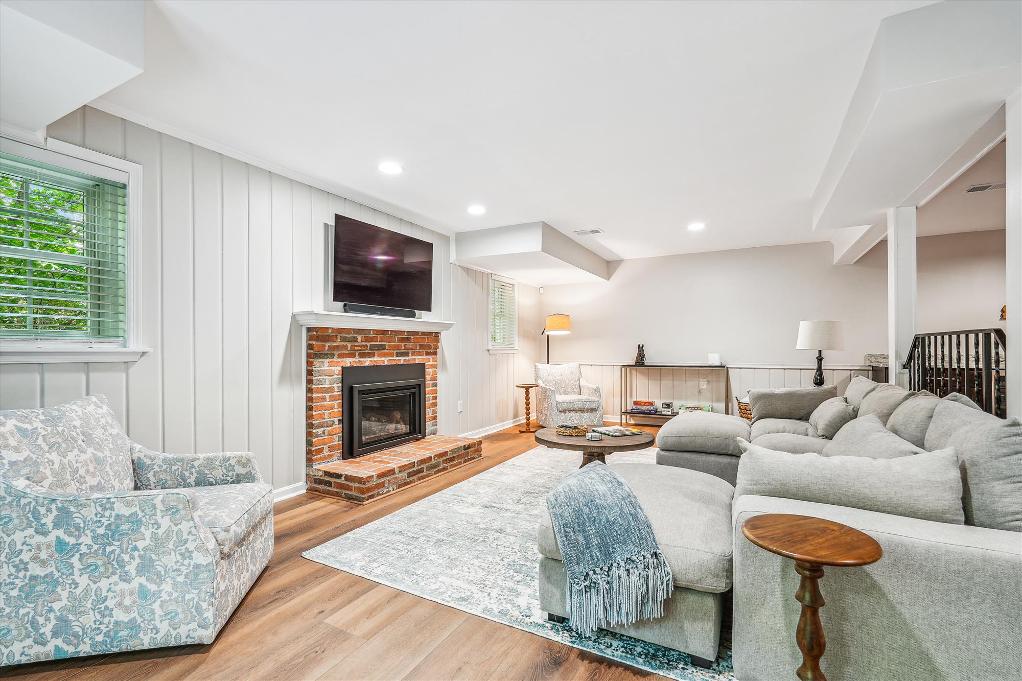 9904 Carter Road Bethesda, MD 20817 - Photo 31 of 41 a living room with furniture a fireplace and a flat screen tv