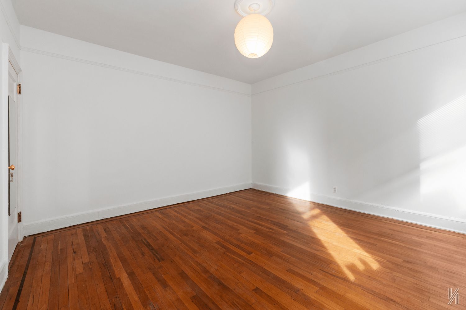 59-11 Queens Boulevard, Unit 3J Queens, NY 11377 - Photo 12 of 18 a view of an empty room with wooden floor and a window