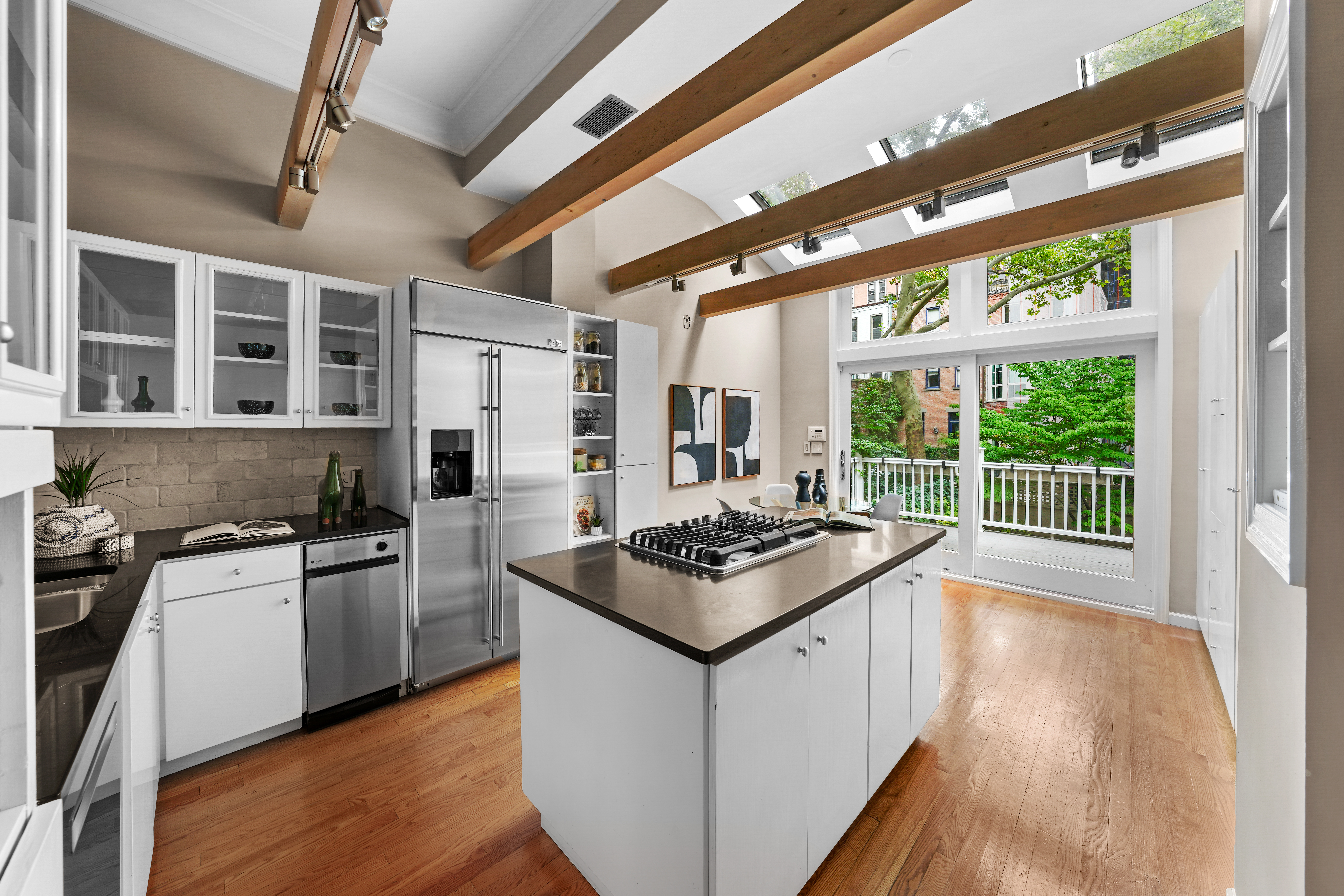 247 East 71st Street Manhattan, NY 10021 - Photo 12 of 31 a kitchen with stainless steel appliances granite countertop a stove and a wooden floors