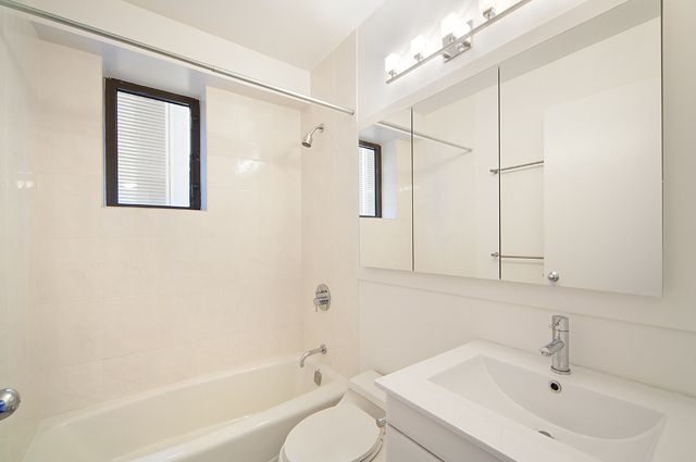 45 East 25th Street, Unit 16A Manhattan, NY 10010 - Photo 5 of 6 a bathroom with a sink a toilet and shower
