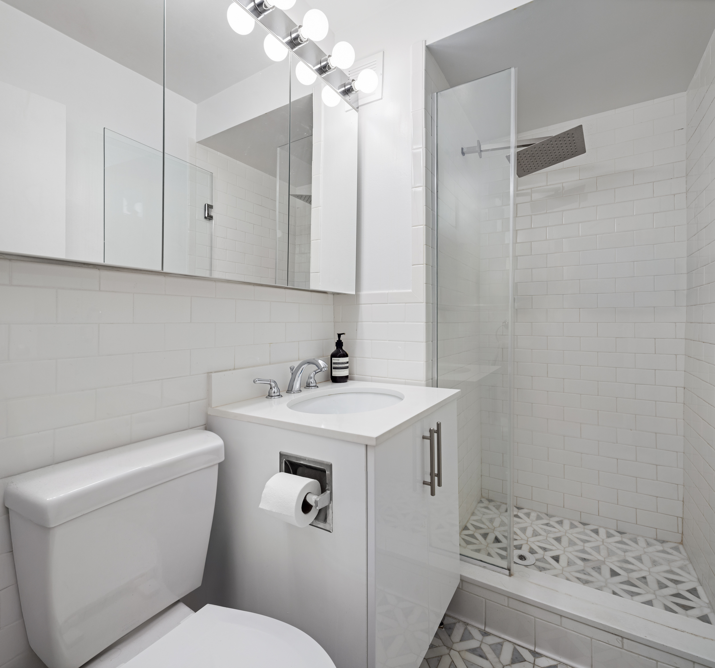 7 East 14th Street, Unit 605 Manhattan, NY 10003 - Photo 7 of 8 a bathroom with a sink a toilet and shower