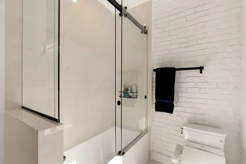 a bathroom with a shower and a shower