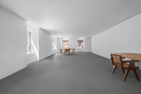 a view of a livingroom with furniture and a window