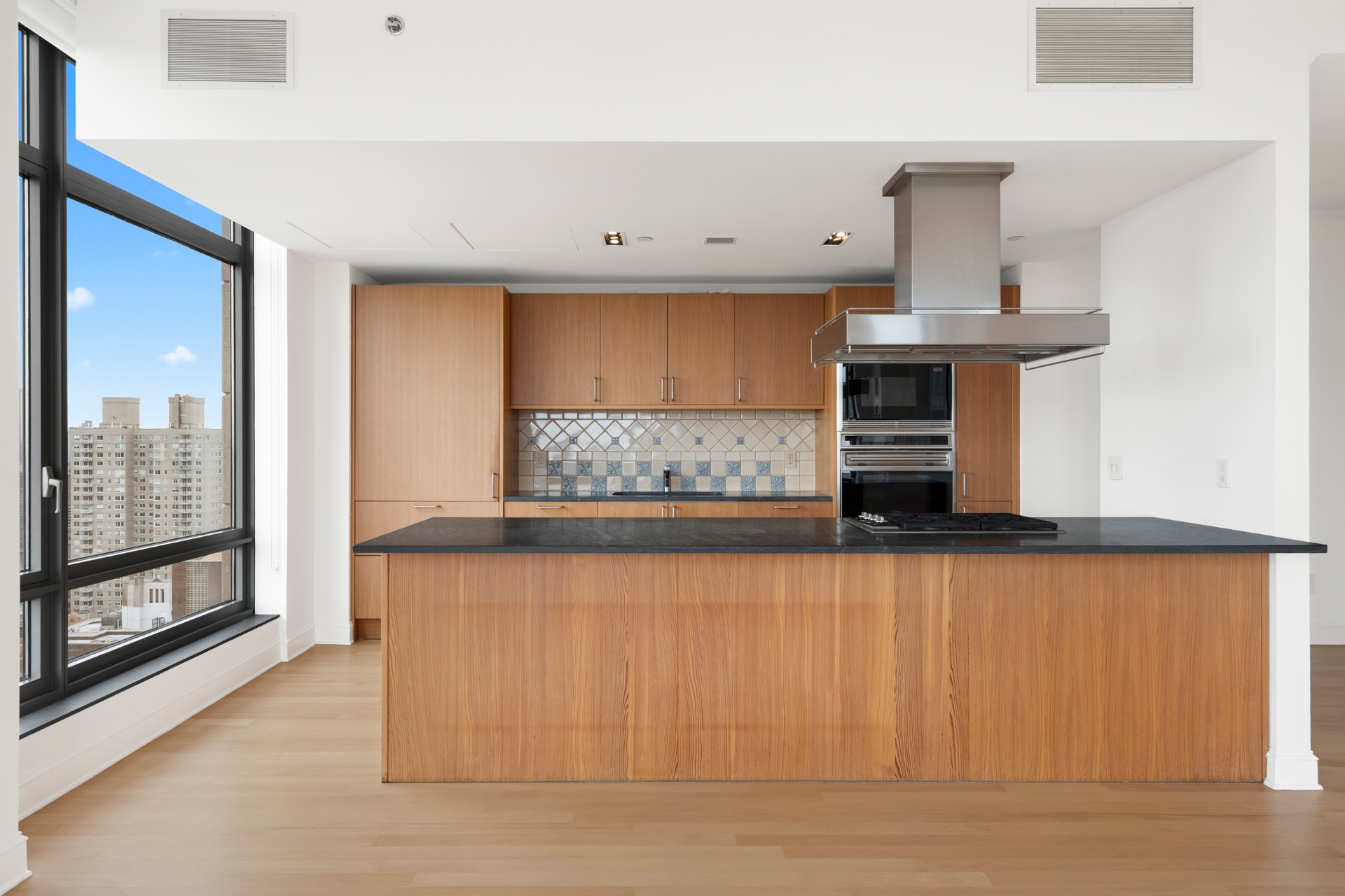 450 East 83rd Street, Unit 23B Manhattan, NY 10028 - Photo 5 of 18 a view of kitchen with stainless steel appliances cabinets and a window
