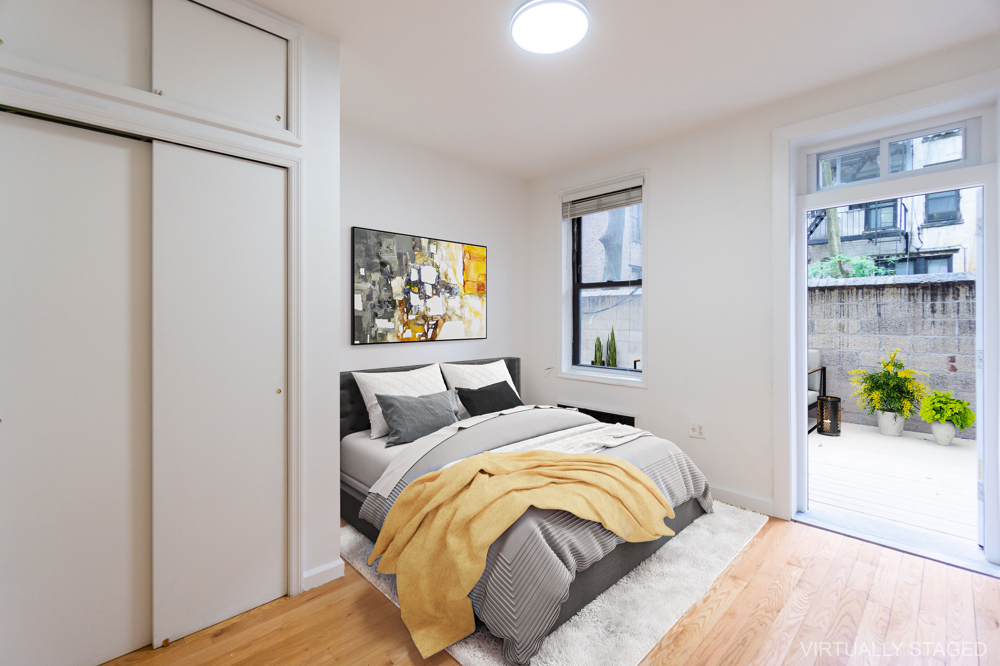 315 East 5th Street, Unit 1C Manhattan, NY 10003 - Photo 5 of 15 a bedroom with bed and painting on the wall