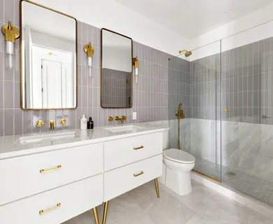 a bathroom with a double vanity sink toilet mirror and shower