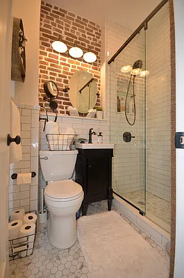 88 Horatio Street, Unit 1C Manhattan, NY 10014 - Photo 6 of 9 a bathroom with a toilet sink and shower