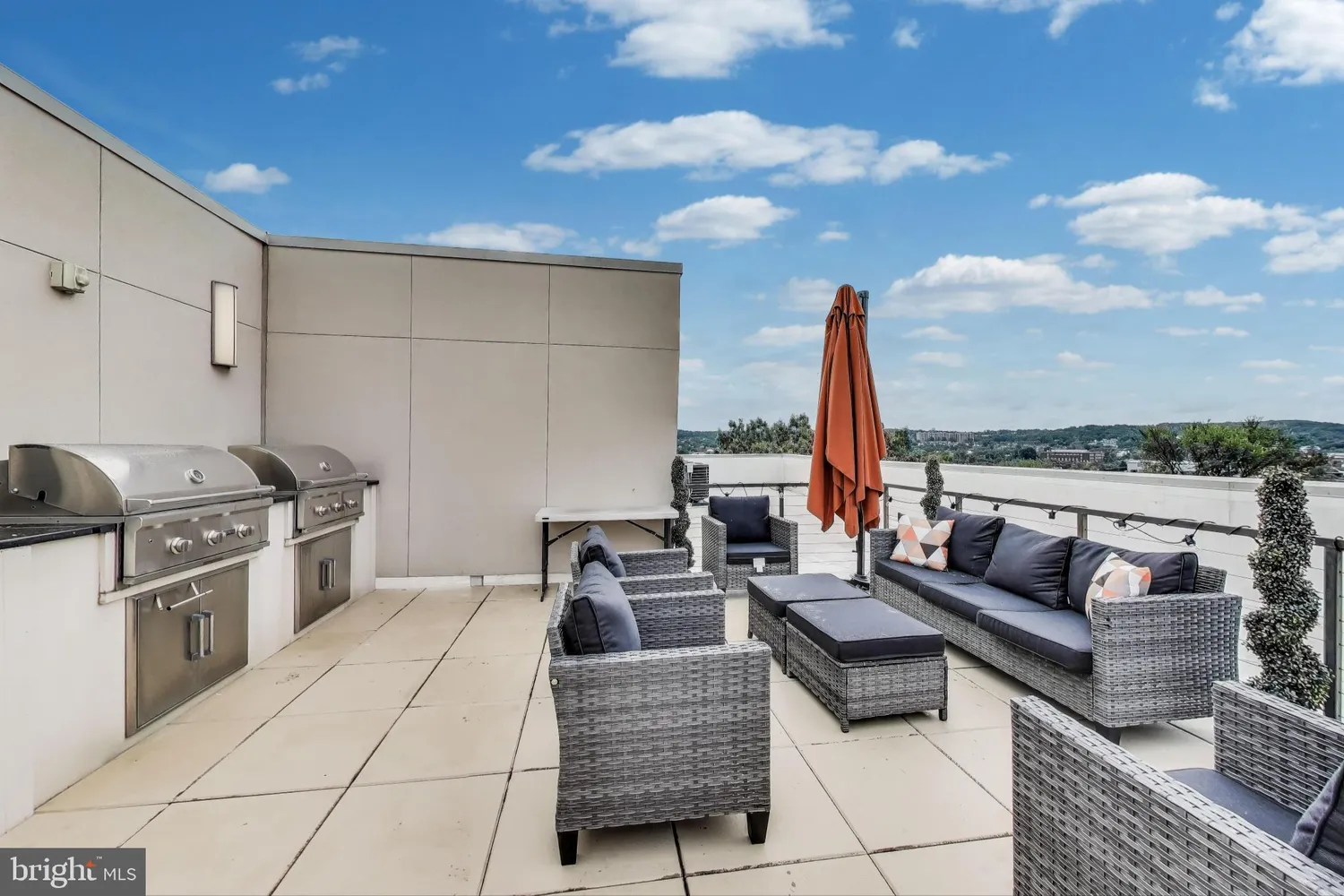a living room with furniture a kitchen and a fireplace