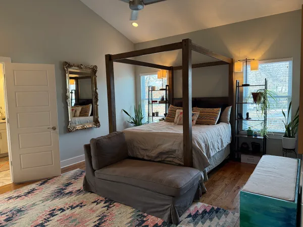 a bedroom with a bed couch and window