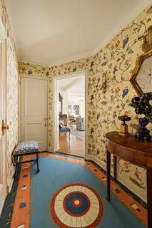 a living room with furniture and a floor to ceiling window