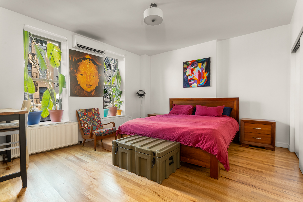 119 East 101st Street, Unit 1A Manhattan, NY 10029 - Photo 6 of 10 a bedroom with a bed and wooden floor