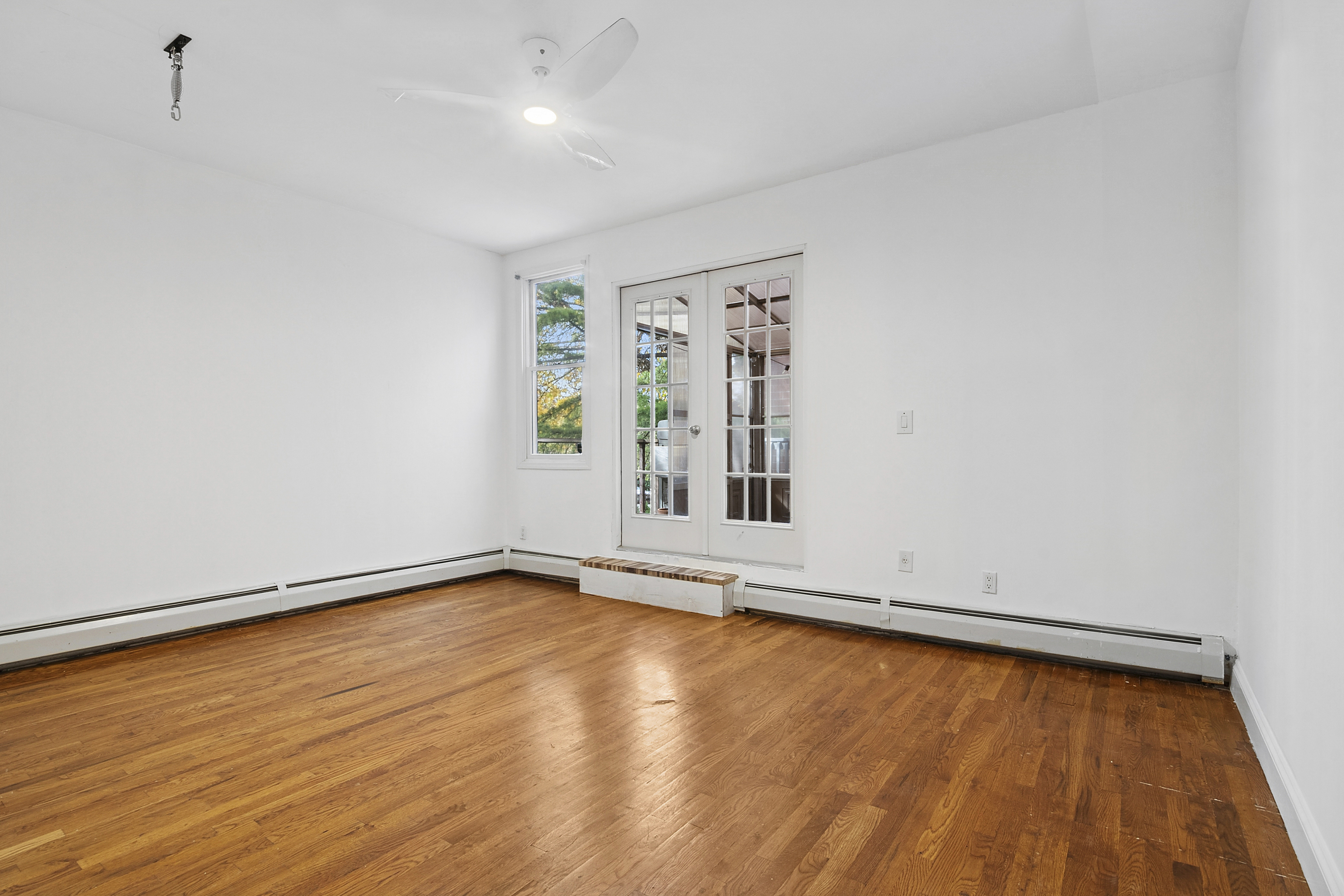 594 6th Avenue, Unit 1 Brooklyn, NY 11215 - Photo 4 of 13 an empty room with wooden floor and windows