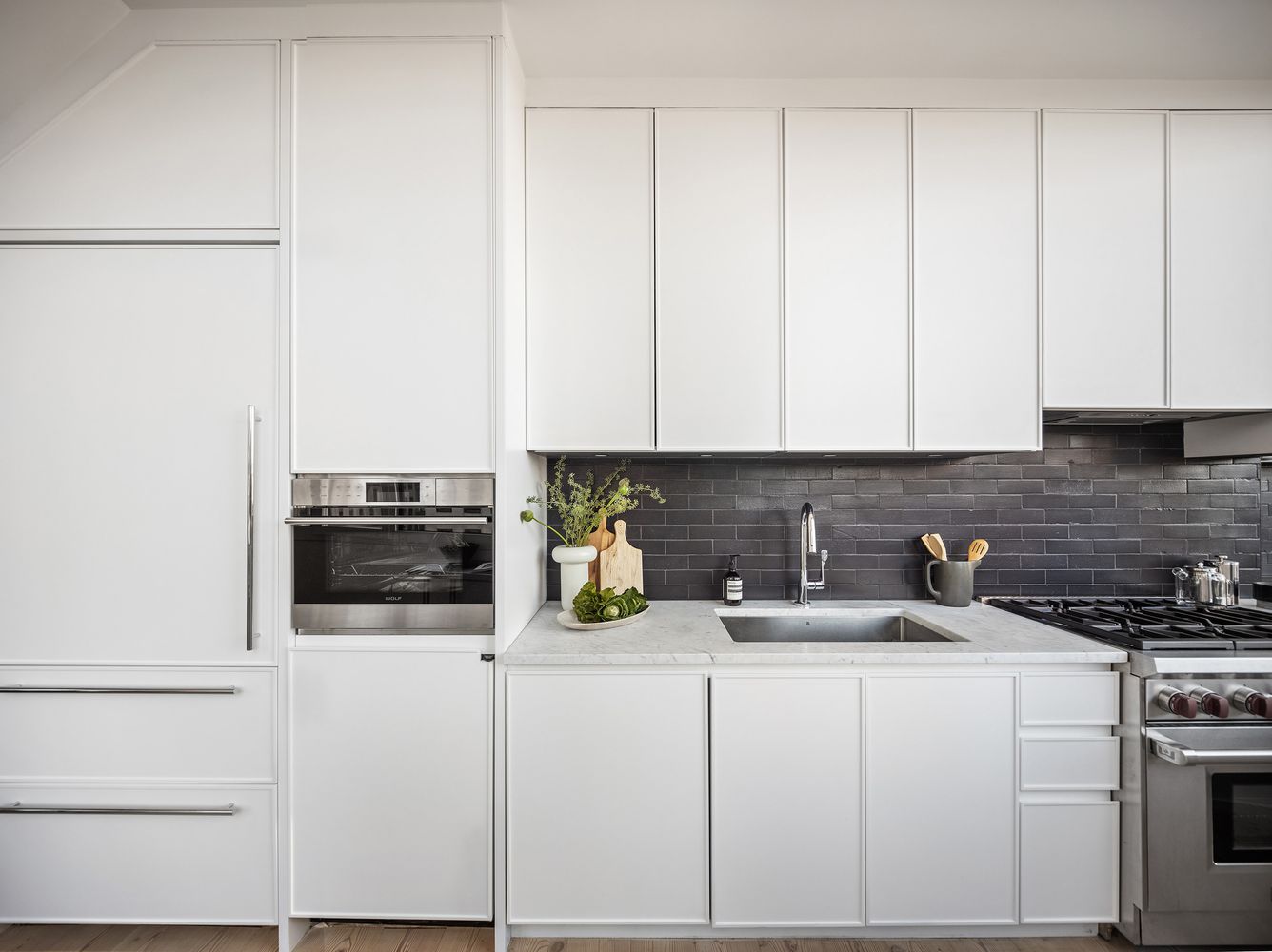a kitchen with white cabinets and white appliances