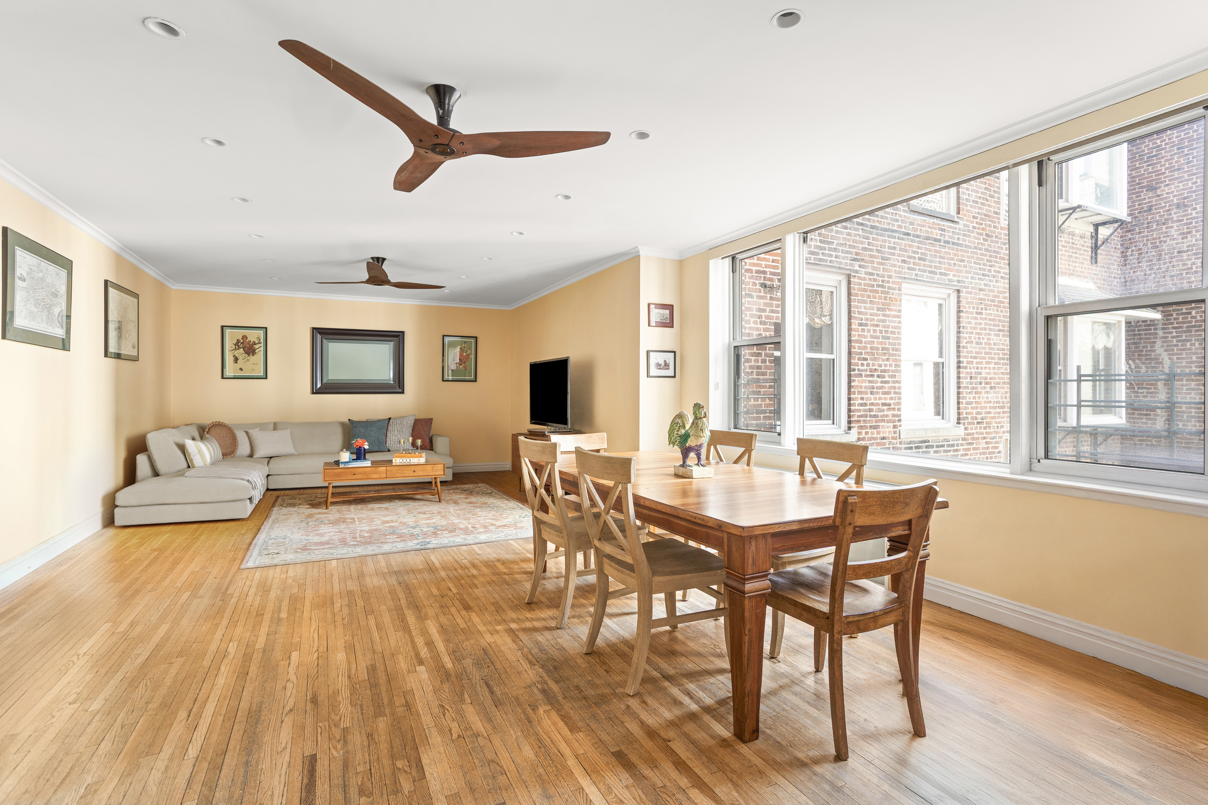 161 East 90th Street, Unit 5C Manhattan, NY 10128 - Photo 6 of 14 a view of a dining room with furniture window and wooden floor