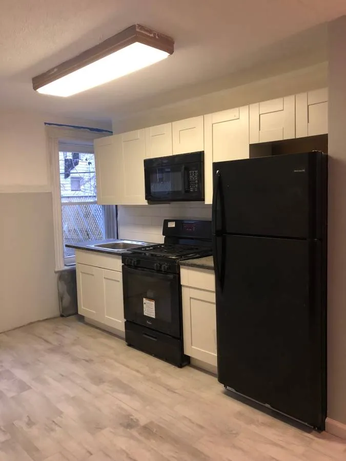 a kitchen with a refrigerator and a stove