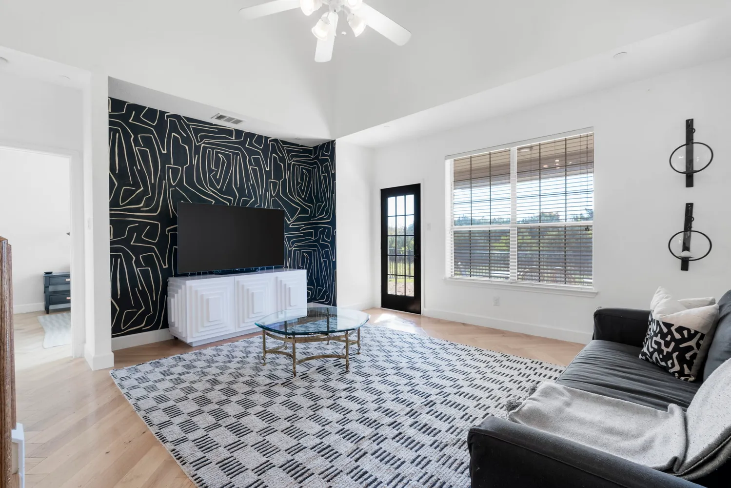 a living room with a couch and a table with wooden floor