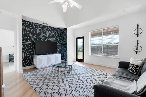 a living room with a couch and a table with wooden floor