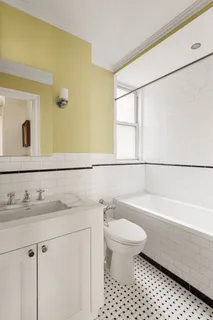 a bathroom with a bathtub sink vanity mirror and toilet