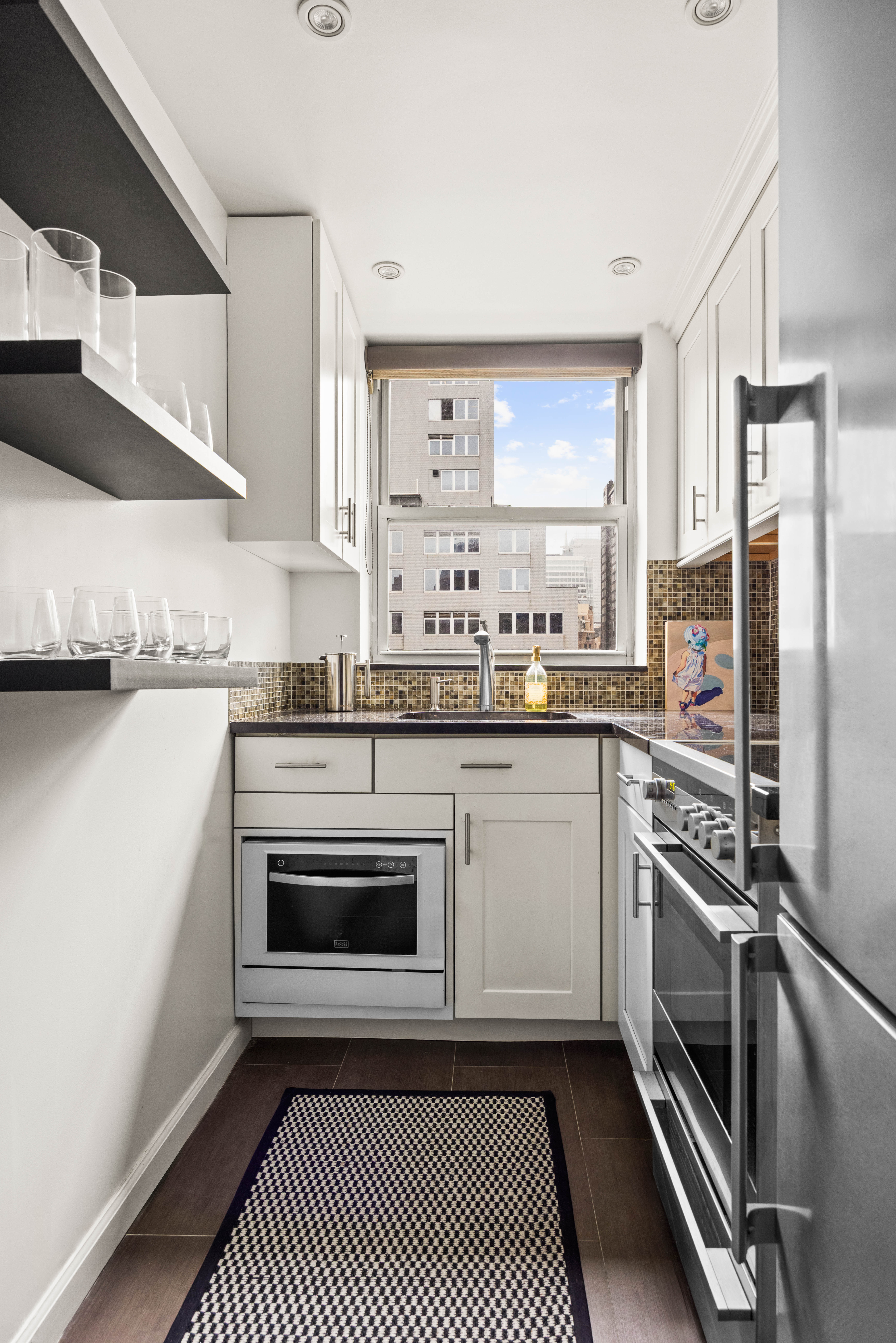 80 Park Avenue, Unit 18B Manhattan, NY 10016 - Photo 7 of 10 a kitchen with a sink stove and refrigerator