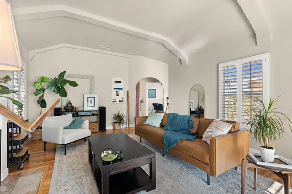 a living room with furniture and wooden floor