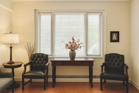 a dining room with furniture and a window
