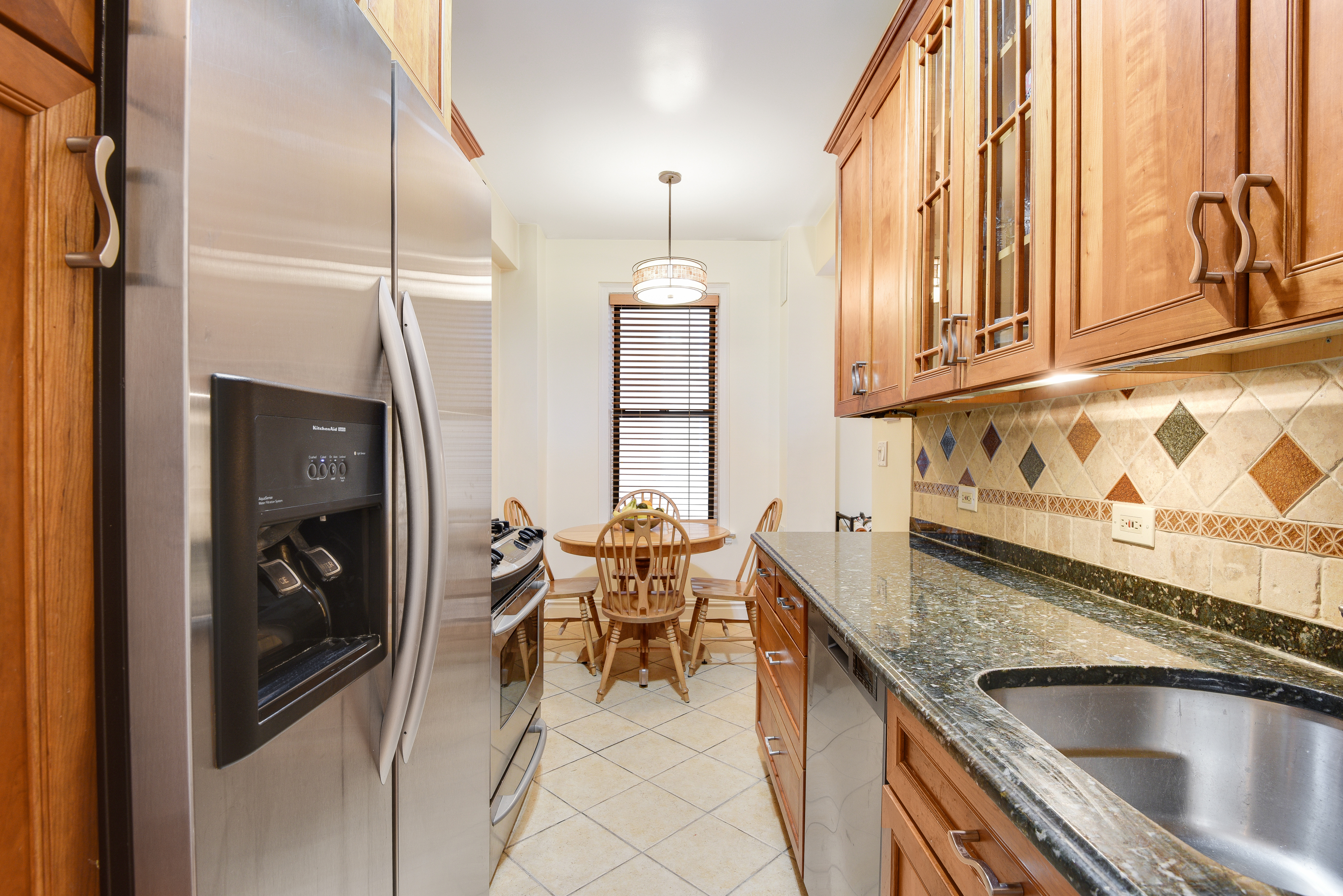 321 West 90th Street, Unit 2F/3F Manhattan, NY 10024 - Photo 5 of 15 a kitchen with stainless steel appliances granite countertop a sink dishwasher and a refrigerator with wooden floor