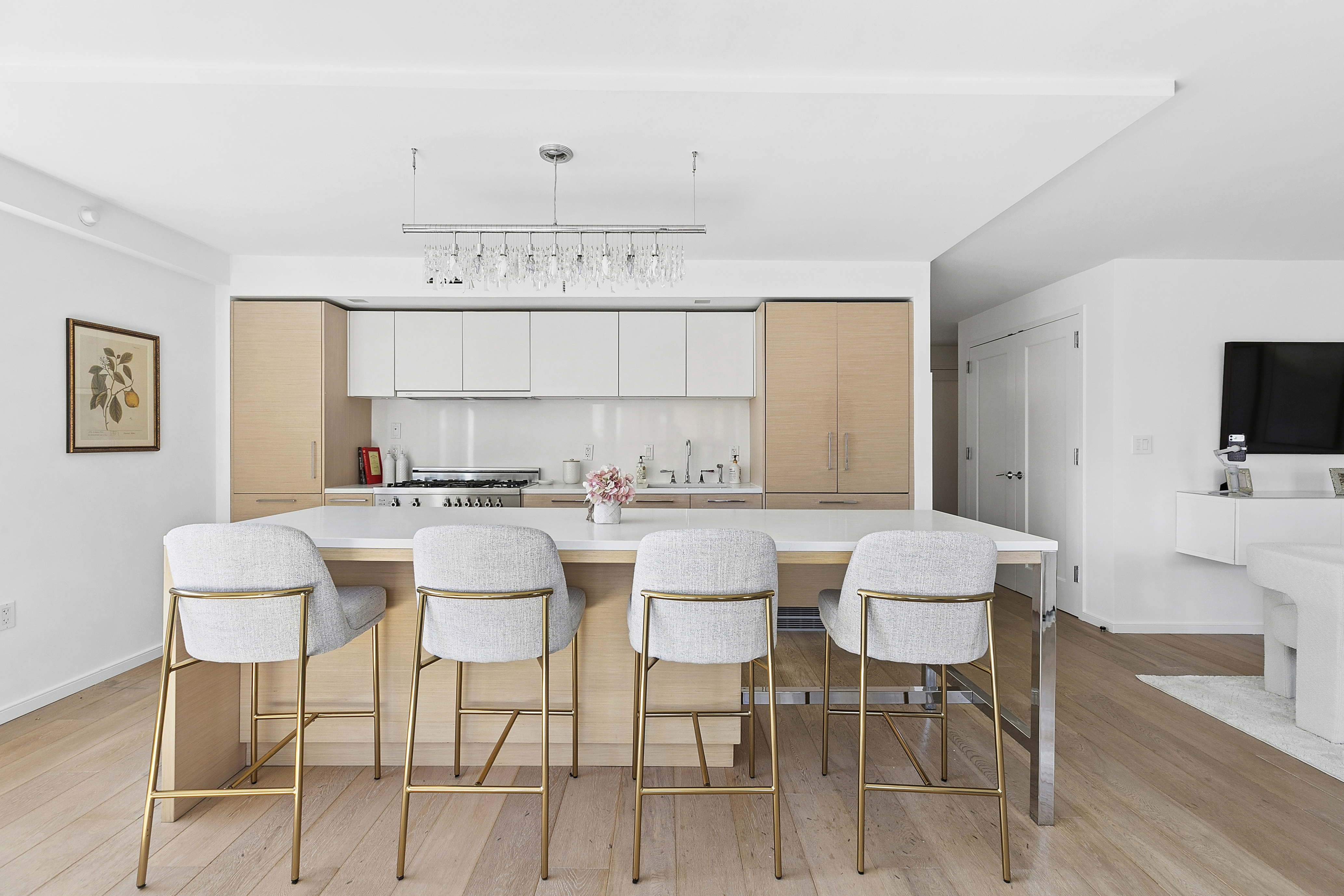 101 West 87th Street, Unit 505 Manhattan, NY 10024 - Photo 4 of 15 a kitchen with a dining table chairs and white cabinets