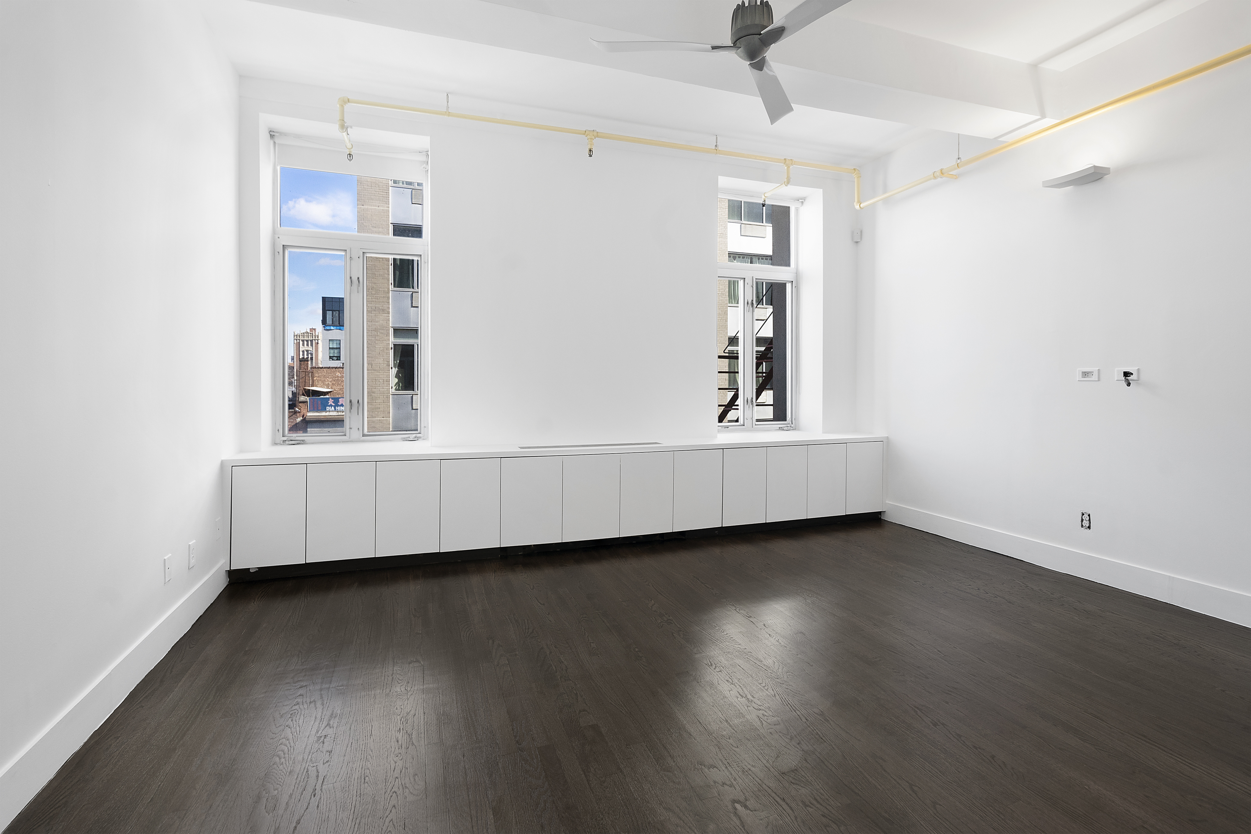 91 Grand Avenue, Unit 2D Brooklyn, NY 11205 - Photo 8 of 16 a view of wooden floor and windows in a room