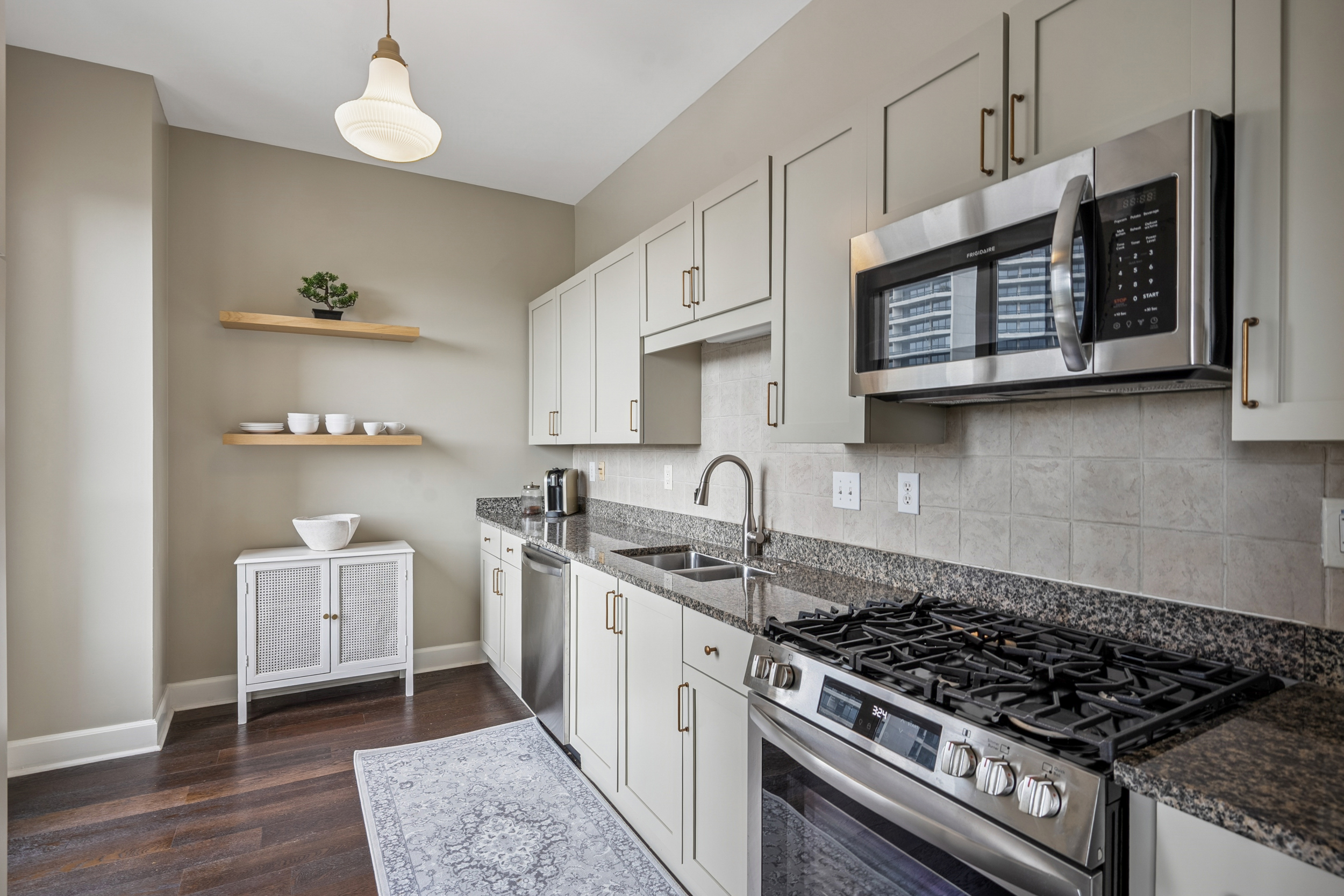 2626 Peachtree Road, Unit 1108 Atlanta, GA 30305 - Photo 9 of 25 a kitchen with stainless steel appliances granite countertop a sink stove and cabinets