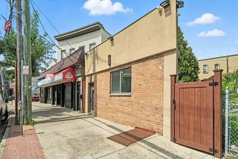 a view of a house with a backyard and trees