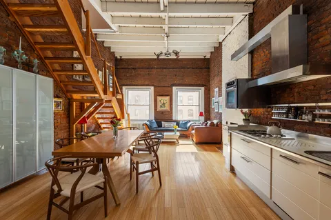 a kitchen with stainless steel appliances granite countertop a stove and cabinets
