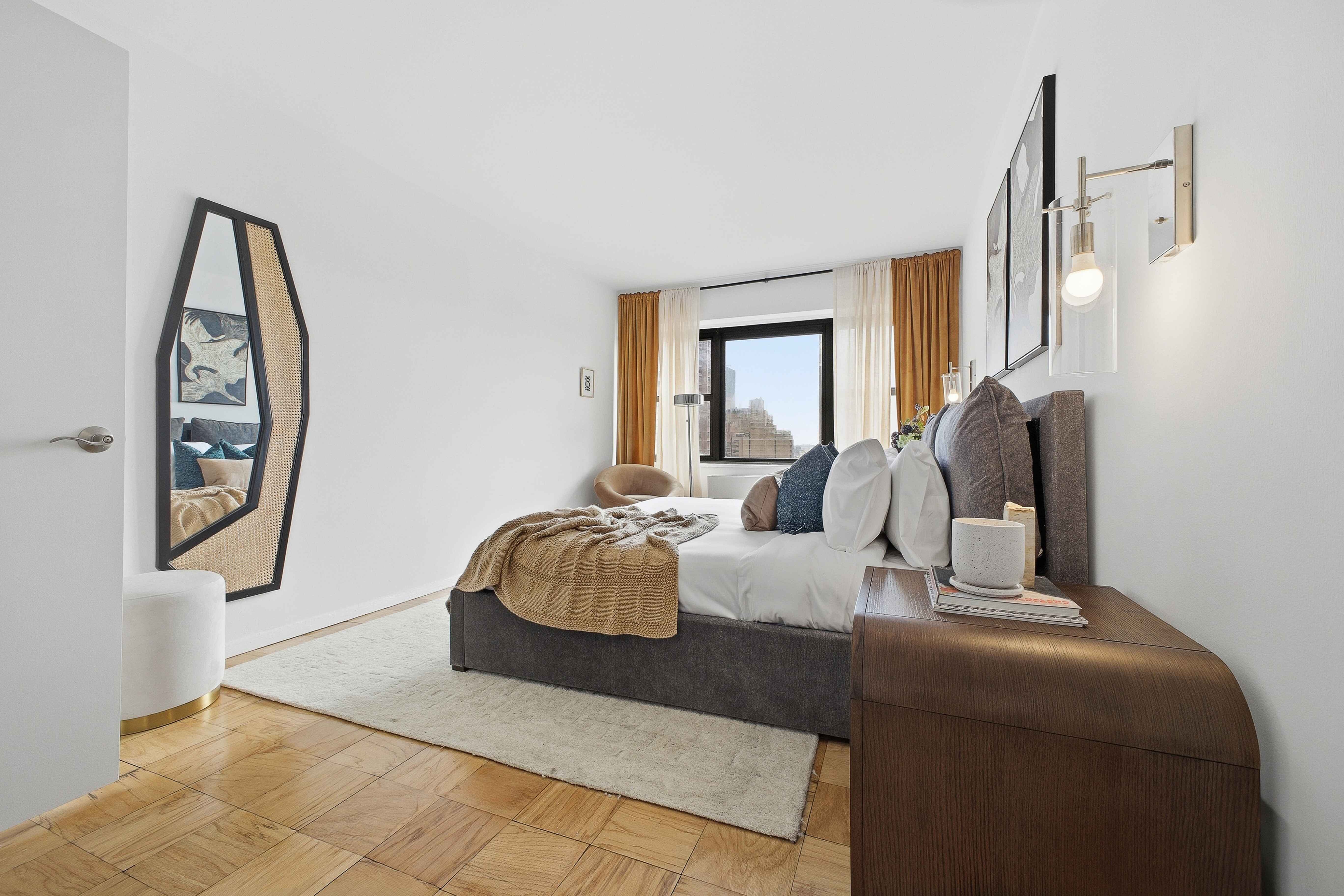 160 East 38th Street, Unit 26FG Manhattan, NY 10016 - Photo 9 of 23 a living room with furniture and a large window