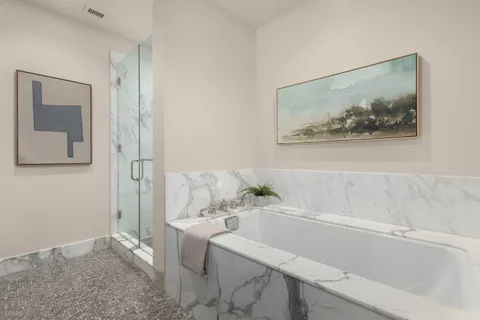 a bathroom with a bathtub and a shower