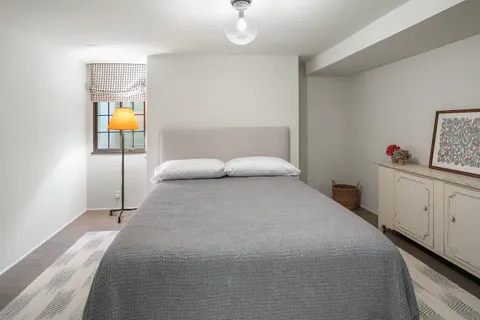 a bedroom with a bed and window